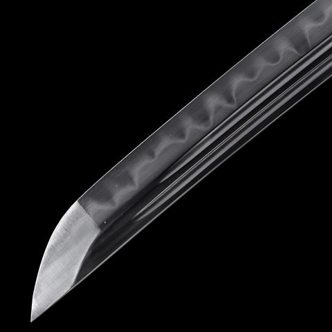 Traditional Japanese sword forging with a visible clay-tempered hamon

